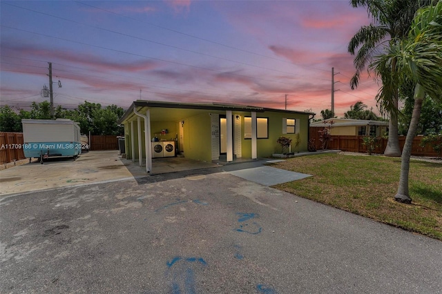 manufactured / mobile home featuring a lawn and a carport