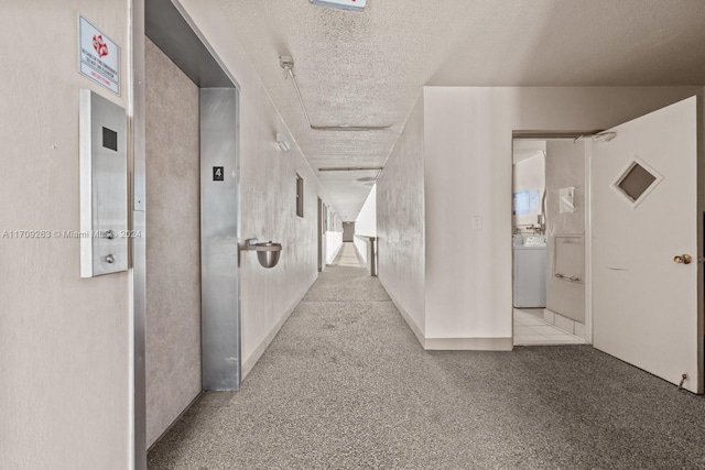 421 NE 14th Ave Unit 405, Hallandale Beach, FL 33009 - corridor featuring washer / dryer, a textured ceiling, carpet floors, and elevator