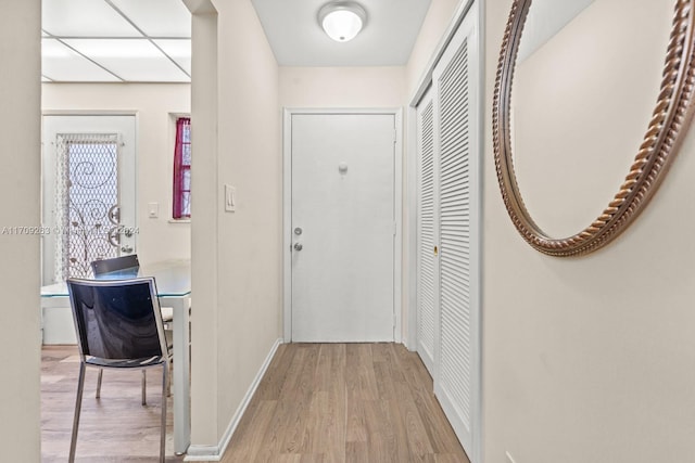 corridor with light hardwood / wood-style floors