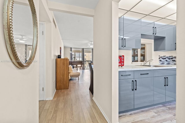 hall featuring sink and light hardwood / wood-style floors