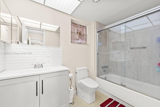 full bathroom with toilet, vanity, and combined bath / shower with glass door