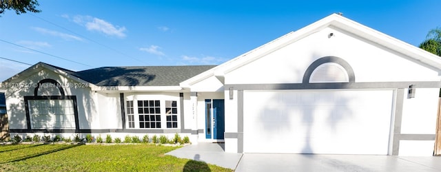 view of front of property with a garage and a front lawn