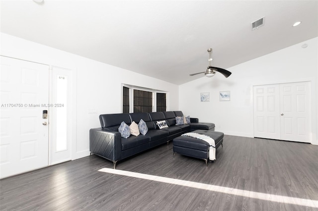 living room with vaulted ceiling, ceiling fan, and dark wood-type flooring