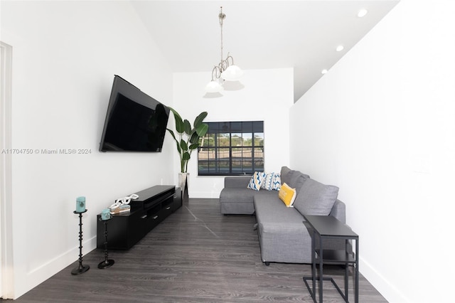 living room featuring high vaulted ceiling, dark hardwood / wood-style floors, and an inviting chandelier