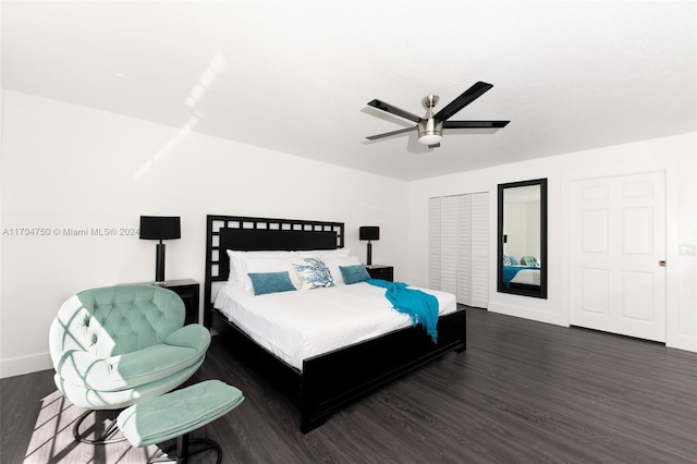 bedroom with dark hardwood / wood-style flooring, a closet, and ceiling fan