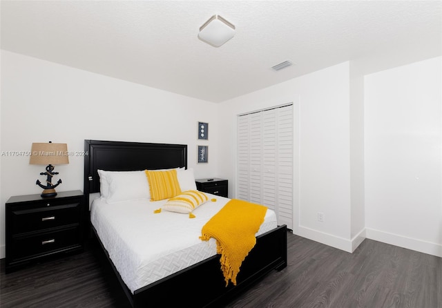 bedroom featuring dark hardwood / wood-style flooring and a closet