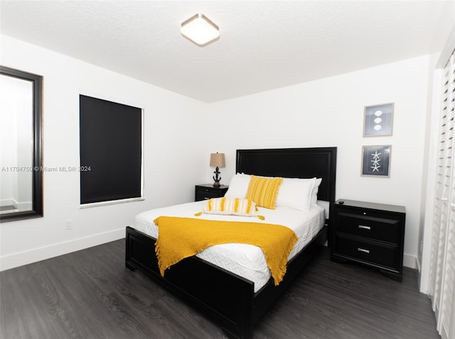 bedroom with dark wood-type flooring