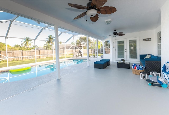 view of swimming pool with glass enclosure, french doors, and a patio