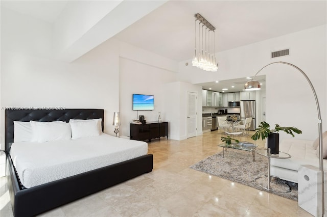 bedroom featuring stainless steel fridge