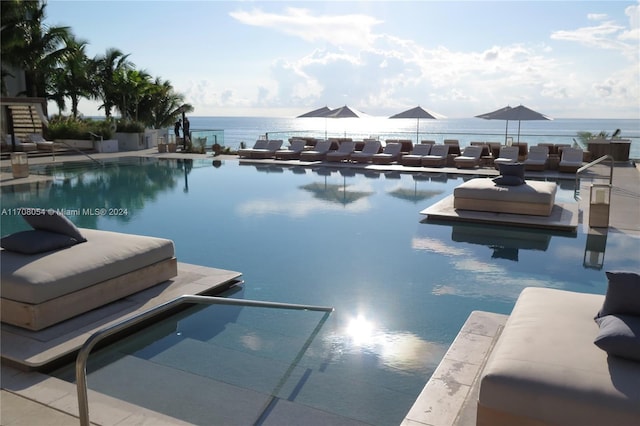 view of swimming pool with a water view