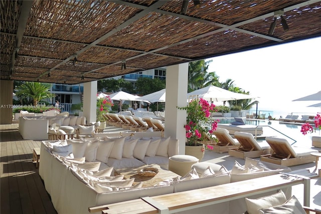 view of patio with a deck with water view and an outdoor hangout area