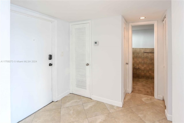 hall with light tile patterned flooring