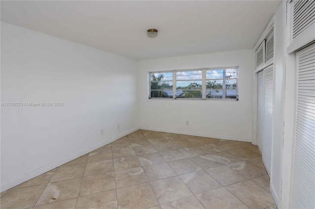 unfurnished bedroom with light tile patterned flooring