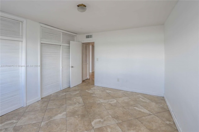 unfurnished bedroom with light tile patterned floors