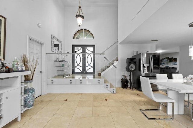 tiled entryway with a towering ceiling