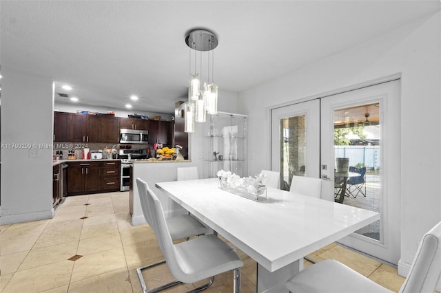 dining space with light tile patterned flooring and french doors