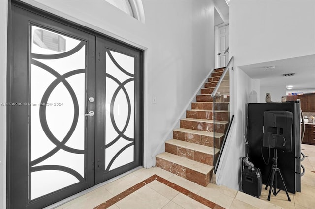 stairs with tile patterned floors