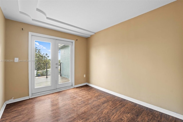 spare room featuring french doors and hardwood / wood-style floors