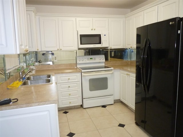 kitchen featuring white appliances, backsplash, sink, light tile patterned flooring, and white cabinetry