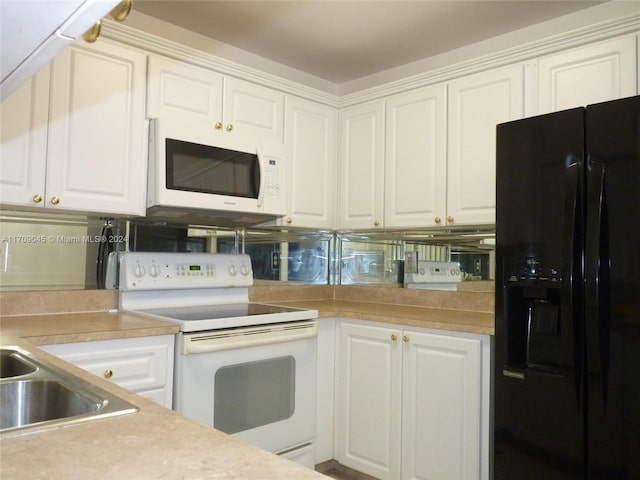 kitchen featuring white cabinetry and white appliances