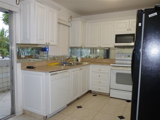 kitchen with white cabinetry, sink, and white appliances