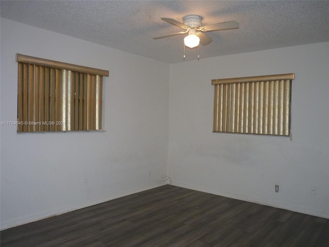 spare room with ceiling fan, dark hardwood / wood-style flooring, and a textured ceiling