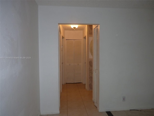 hall featuring light tile patterned flooring