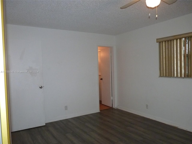 unfurnished room featuring a textured ceiling, ceiling fan, and dark wood-type flooring