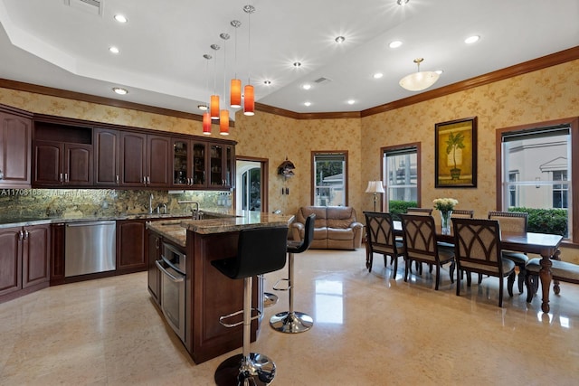 kitchen featuring dishwasher, pendant lighting, a wealth of natural light, and dark stone countertops