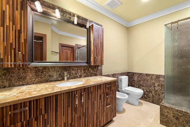 bathroom with vanity, toilet, ornamental molding, and a bidet