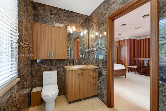 bathroom with a wealth of natural light, ornamental molding, tile walls, and toilet