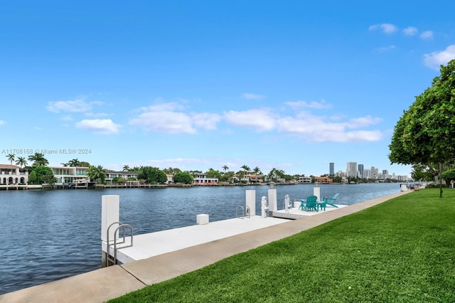 view of dock with a water view and a yard