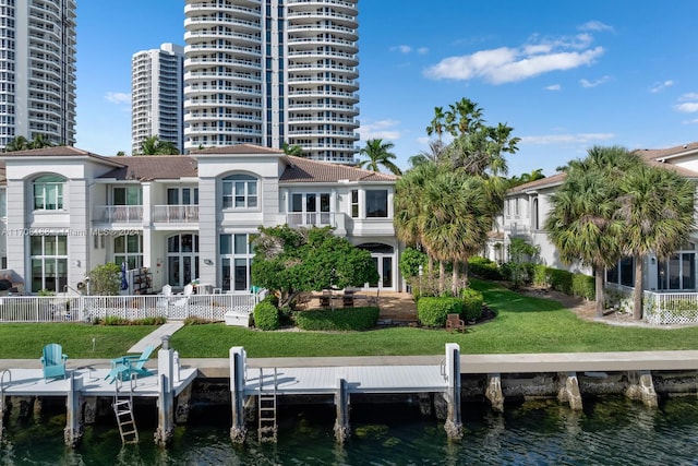 dock area featuring a lawn and a water view