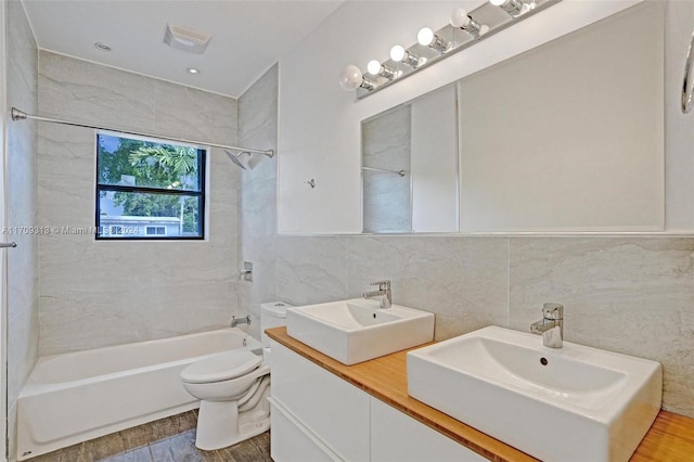 full bathroom featuring backsplash, wood-type flooring, toilet, tile walls, and tiled shower / bath