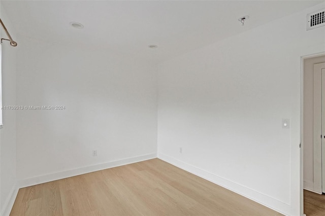 empty room with hardwood / wood-style floors