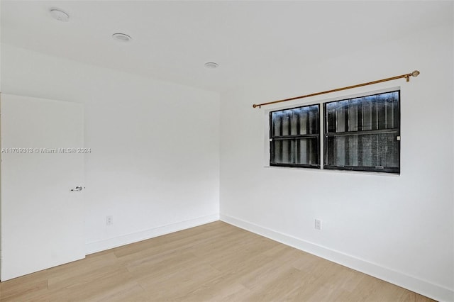 unfurnished room with hardwood / wood-style flooring