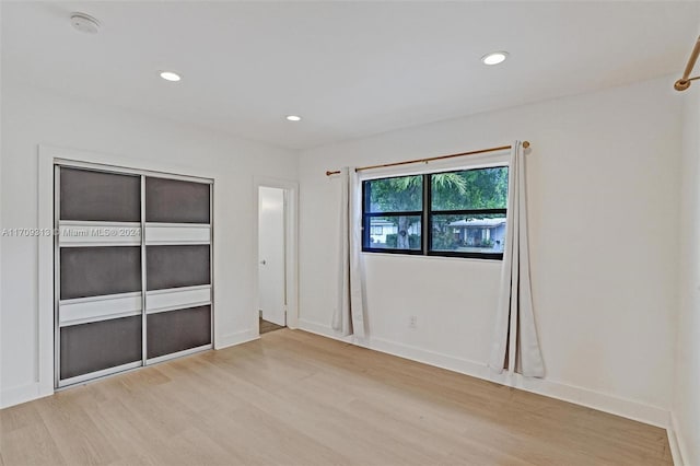 spare room featuring light hardwood / wood-style floors