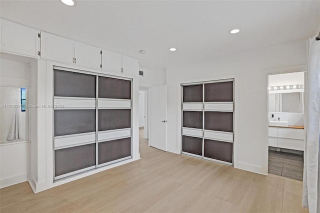 interior space featuring ensuite bathroom and light wood-type flooring