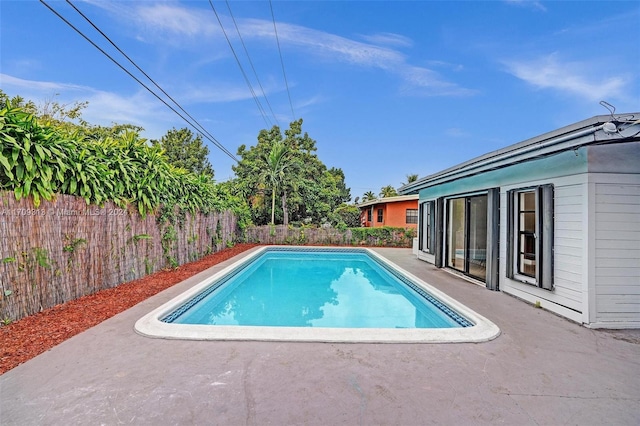 view of swimming pool featuring a patio area