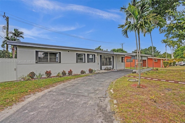 ranch-style home with a front lawn