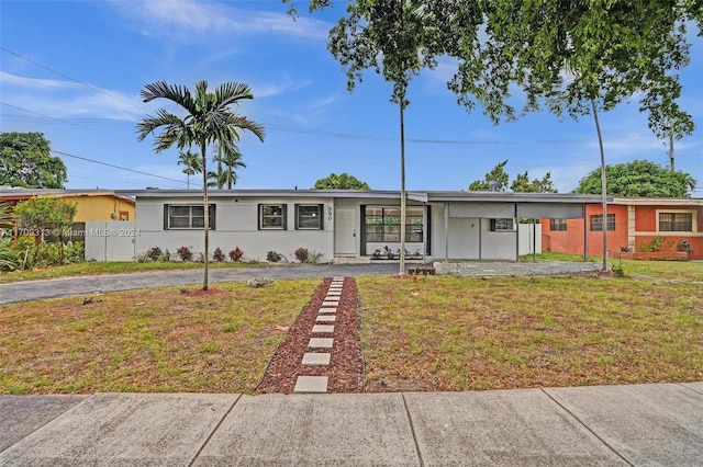 ranch-style house with a front lawn