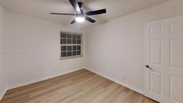 unfurnished room with a ceiling fan, light wood-type flooring, a textured ceiling, and baseboards