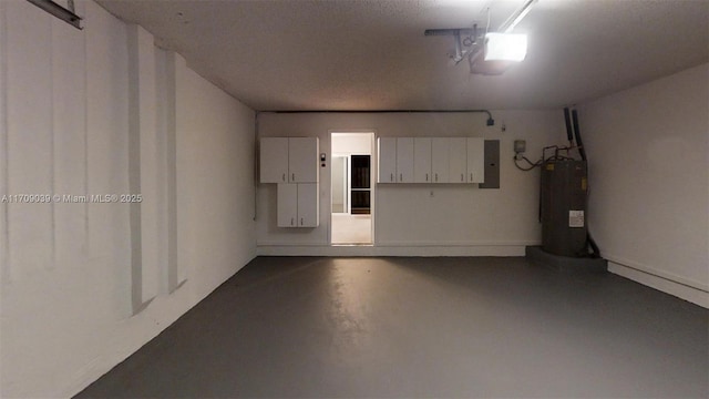 garage featuring water heater, electric panel, and a garage door opener