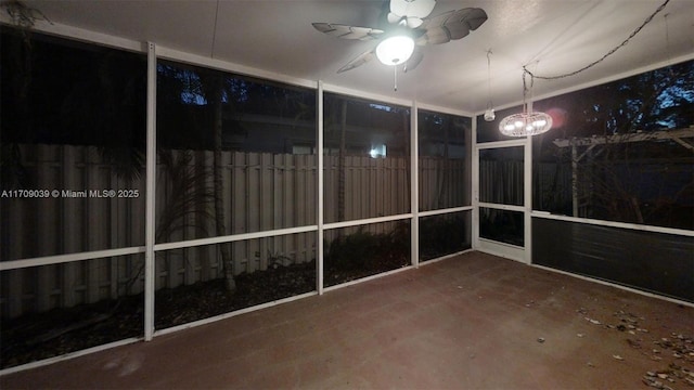 unfurnished sunroom featuring a ceiling fan