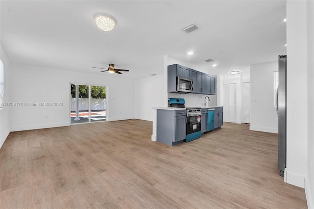 kitchen featuring ceiling fan, light hardwood / wood-style floors, blue cabinetry, and appliances with stainless steel finishes