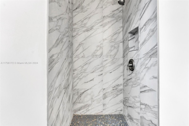 bathroom with tiled shower