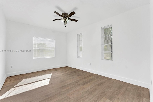 unfurnished room with ceiling fan and hardwood / wood-style flooring