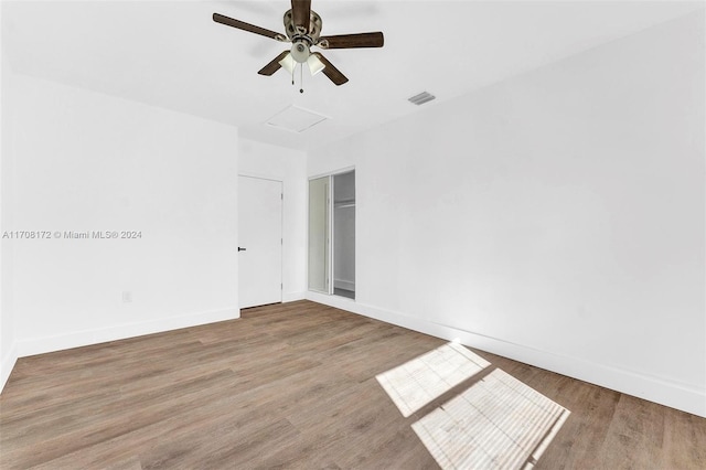 unfurnished room with ceiling fan and hardwood / wood-style floors