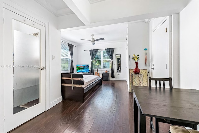 bedroom with ornamental molding and dark wood-type flooring