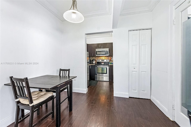 dining room featuring dark wood-type flooring and ornamental molding